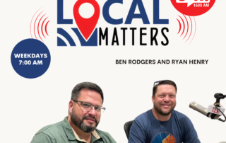 A picture of two men sitting in front of microphones underneath a banner announcing the Local Matters podcast.